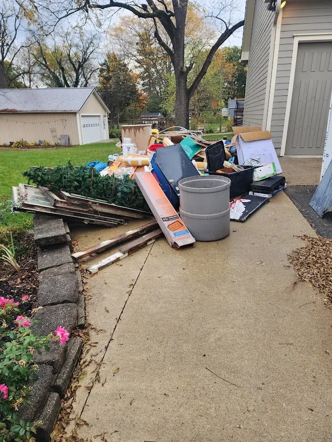 Dumpster being loaded with debris for 3 Yard Dumpster Rental in Erda